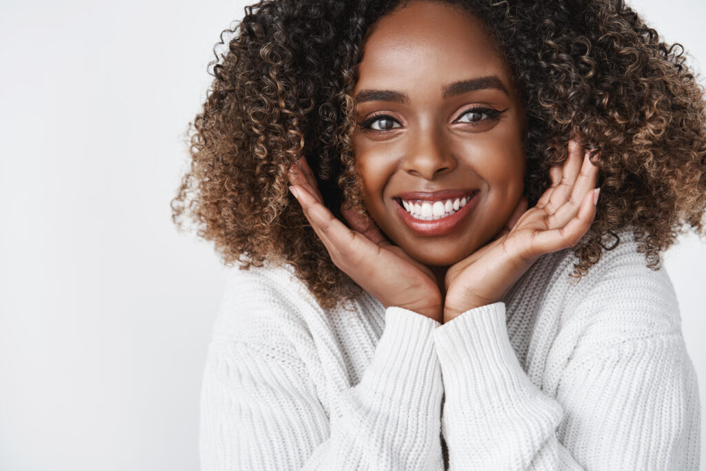 Woman smiles widely after botox.