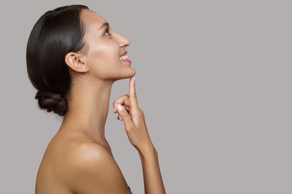 woman pointing at chin botox